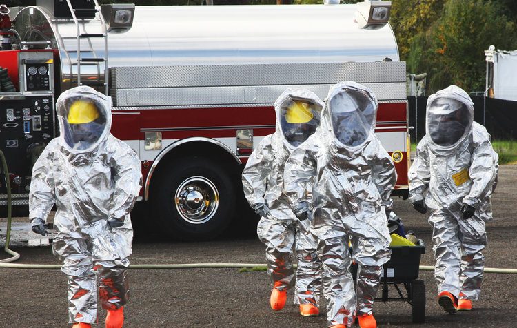In any urban area the fire departments and emergency response teams will conduct disaster preparedness drills. These HAZMAT team members are suited up with a protective suit to protect them from hazardous materials as they head out investigate this mock disaster.